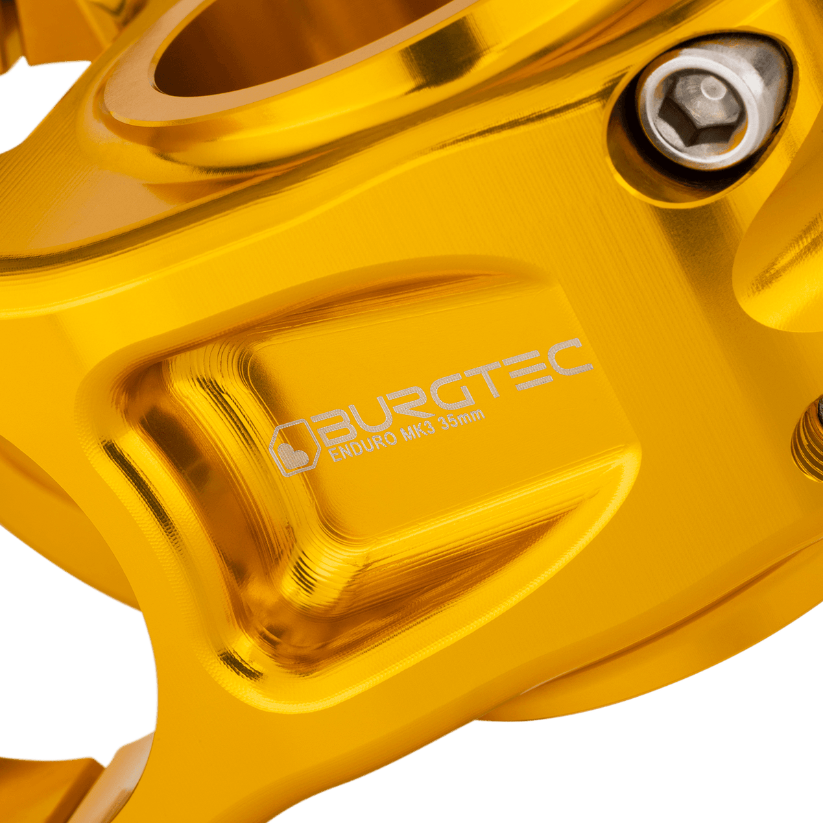Attacco manubrio BURGTEC ENDURO MK3 oro — dettaglio del corpo lavorato