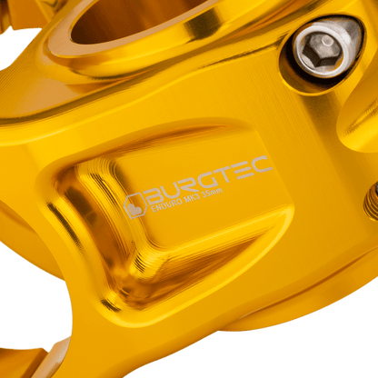 Attacco manubrio BURGTEC ENDURO MK3 oro — dettaglio del corpo lavorato